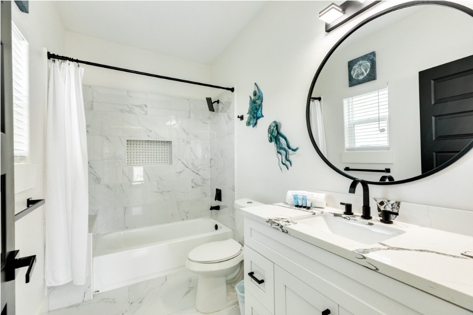 23245 Termini-San Luis Pass Road Galveston, TX 77554 - Photo 34 of 45 a bathroom with a sink a toilet and a mirror