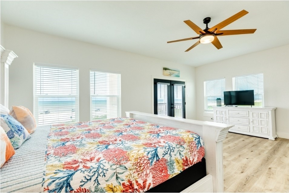 23245 Termini-San Luis Pass Road Galveston, TX 77554 - Photo 38 of 45 a bedroom with a bed and a large window with outer view