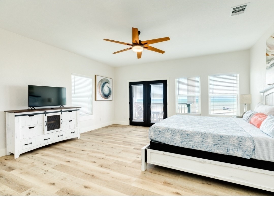 23245 Termini-San Luis Pass Road Galveston, TX 77554 - Photo 41 of 45 a spacious bedroom with a bed and a flat screen tv