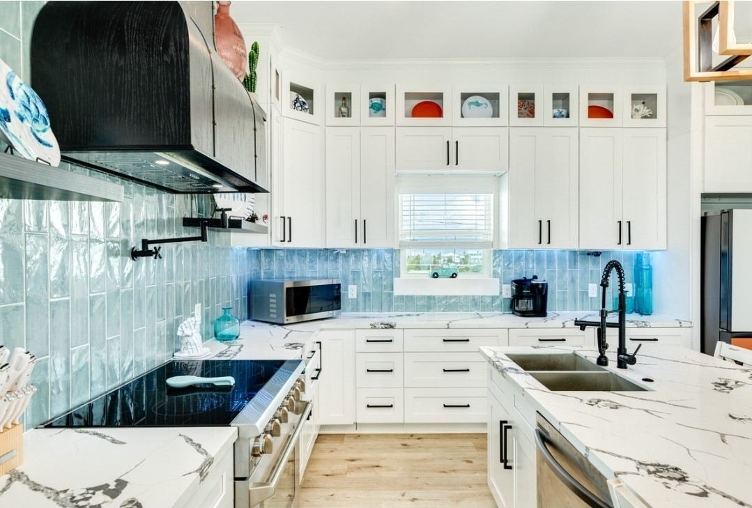 23245 Termini-San Luis Pass Road Galveston, TX 77554 - Photo 9 of 45 a kitchen with a stove a sink and a microwave