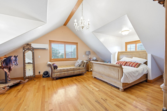 169 Taylor Road, Unit 101 Grantsville, UT 84029 - Photo 16 of 47 Main home - Expansive master bedroom featuring pitched ceilings, wood-finish flooring, a wood beam accent, a chandelier, and a window with plantation shutters