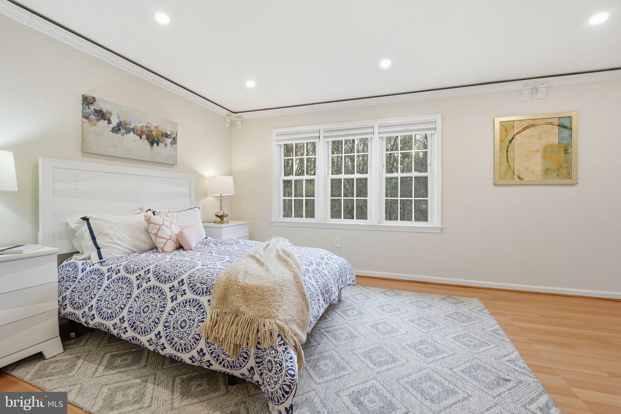 8967 Omega Court Springfield, VA 22152 - Photo 11 of 31 a bedroom with a bed and wooden floor