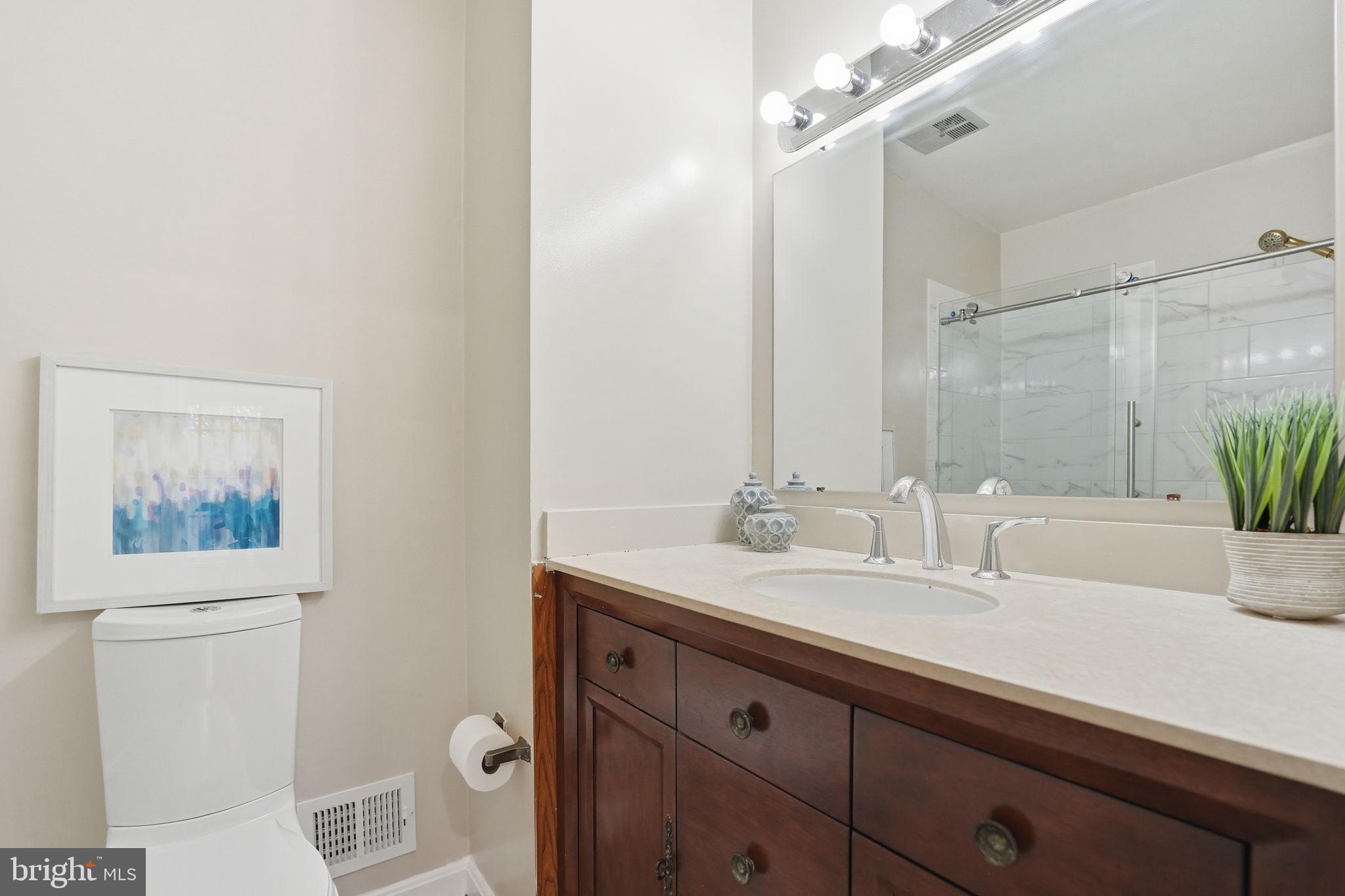 8967 Omega Court Springfield, VA 22152 - Photo 16 of 31 a bathroom with a sink and a mirror