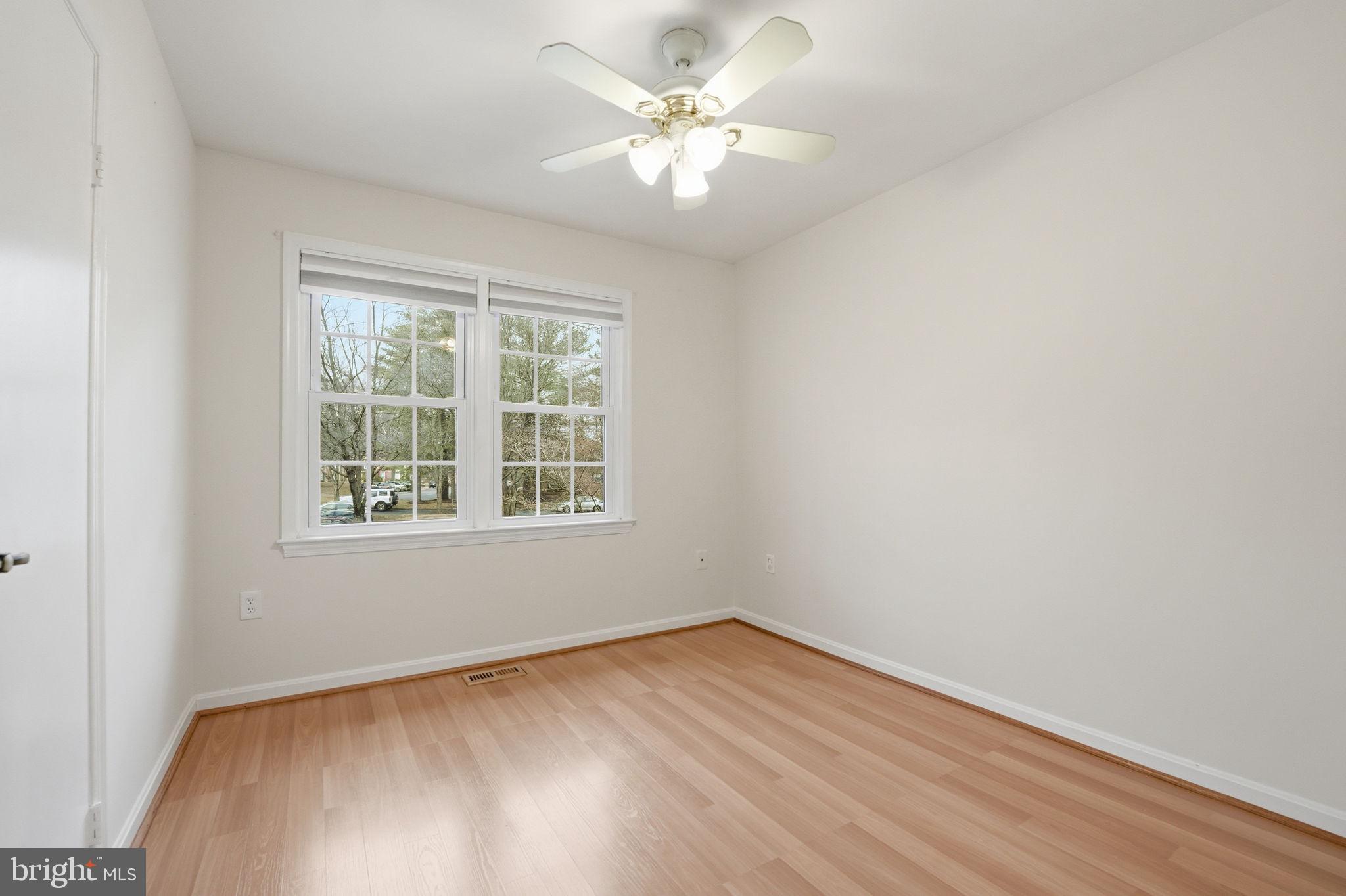 8967 Omega Court Springfield, VA 22152 - Photo 19 of 31 an empty room with a window and a fan