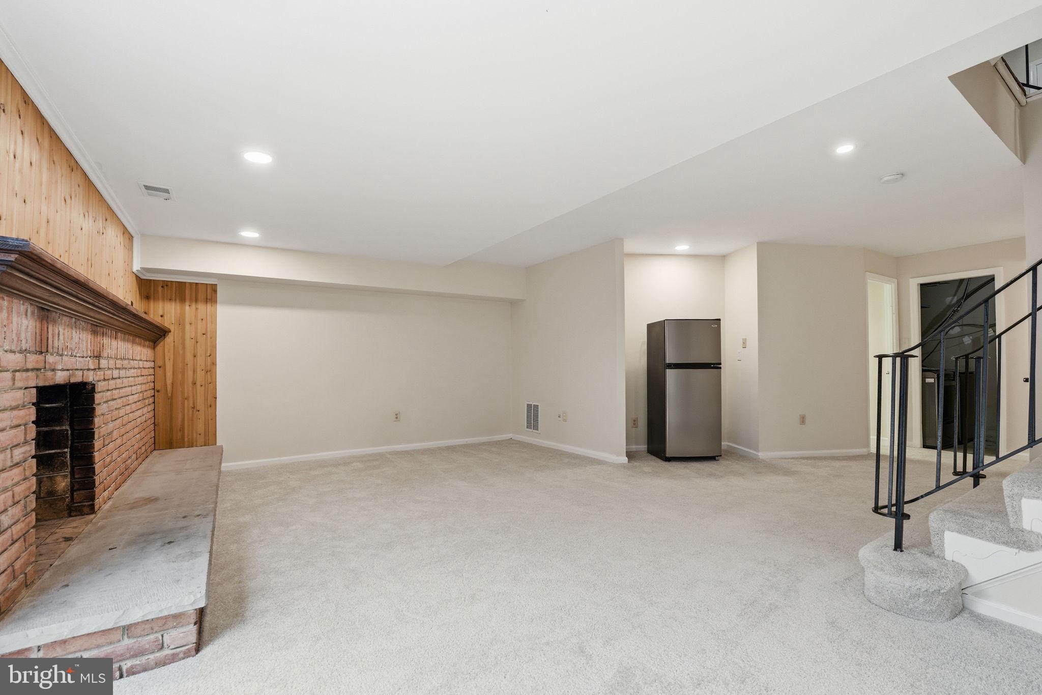 8967 Omega Court Springfield, VA 22152 - Photo 22 of 31 a view of empty room with fireplace