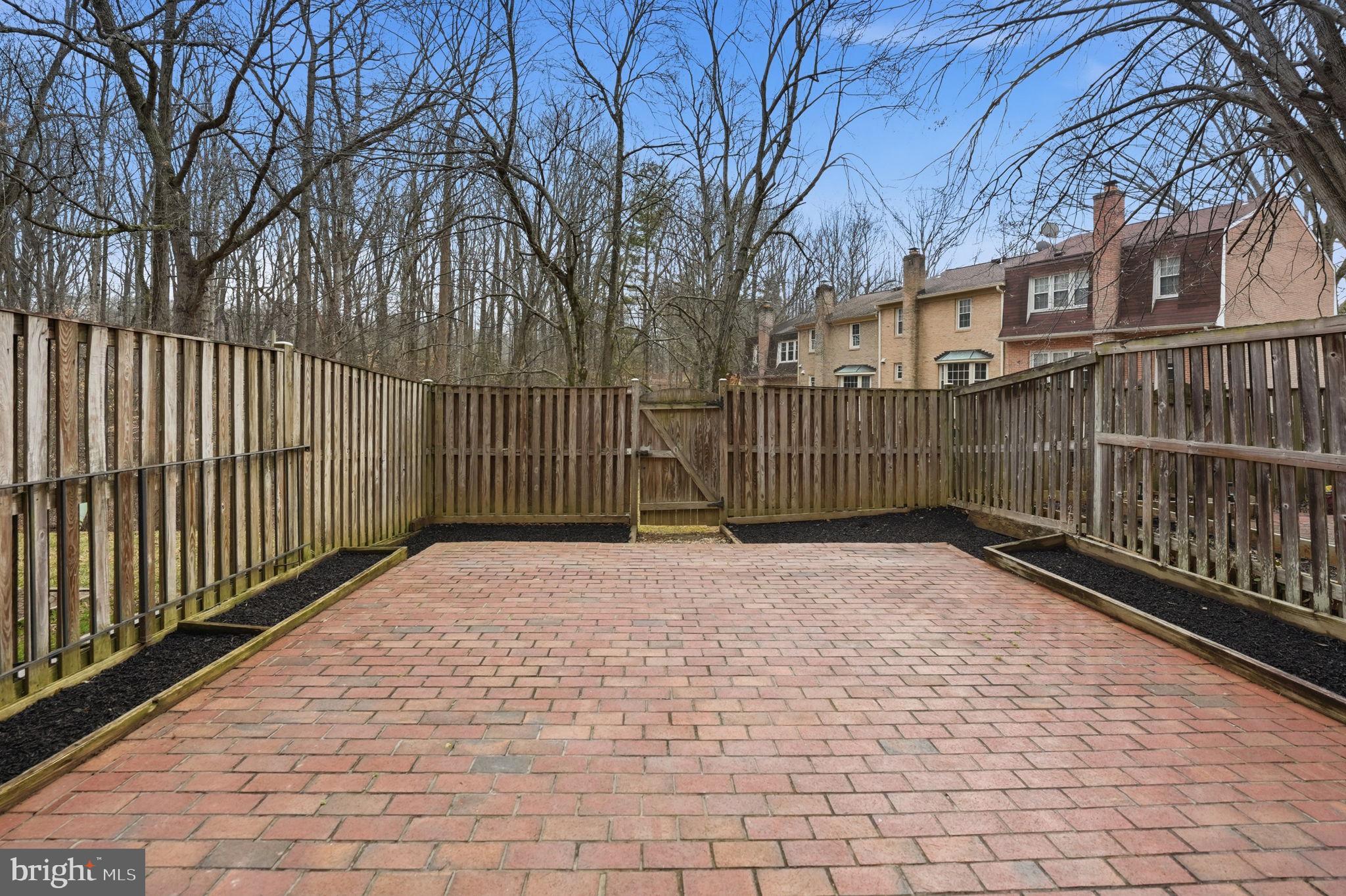 8967 Omega Court Springfield, VA 22152 - Photo 25 of 31 a view of a building with a wooden fence