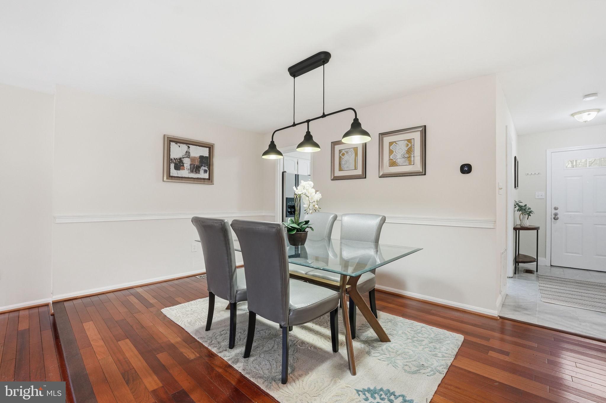 8967 Omega Court Springfield, VA 22152 - Photo 6 of 31 a view of a dining room with furniture and wooden floor