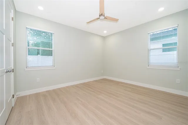 a bathroom with a granite countertop sink a toilet and a mirror