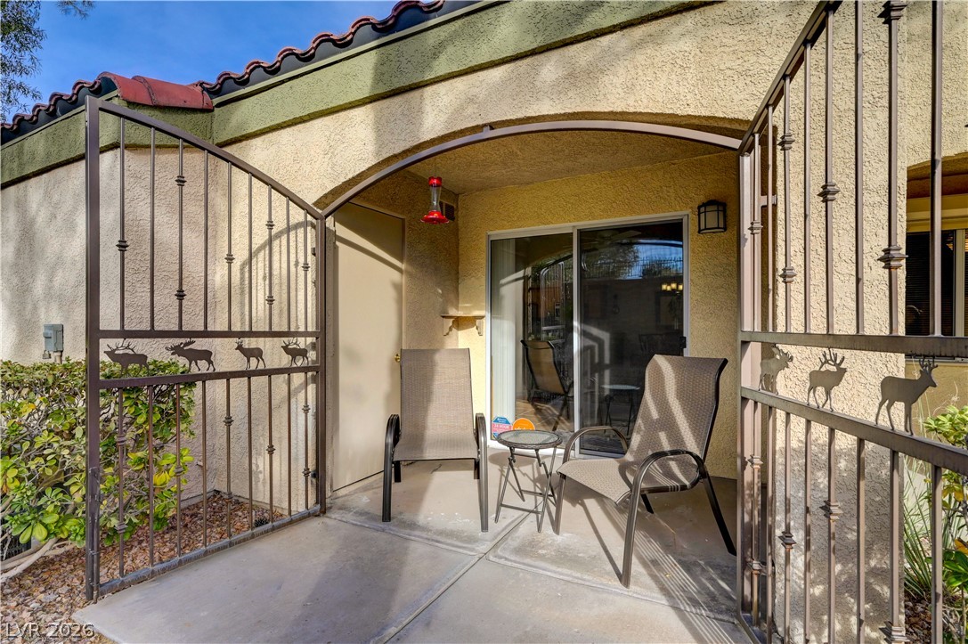 7885 West Flamingo Road, Unit 1071 Las Vegas, NV 89147 - Photo 24 of 28 Enter through a charming wrought iron gate to a private outdoor patio, ideal for peaceful moments.