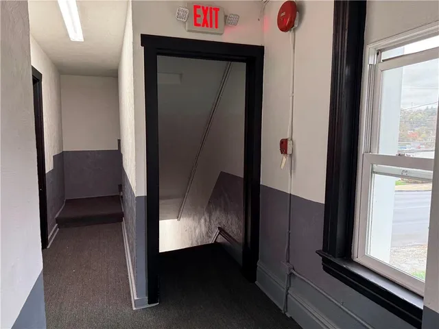 a view of hallway with furniture and a window