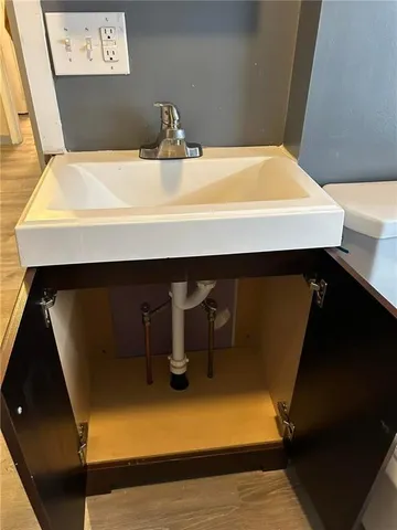 a kitchen with a sink and cabinets