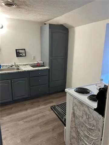 a stove top oven sitting inside of a kitchen