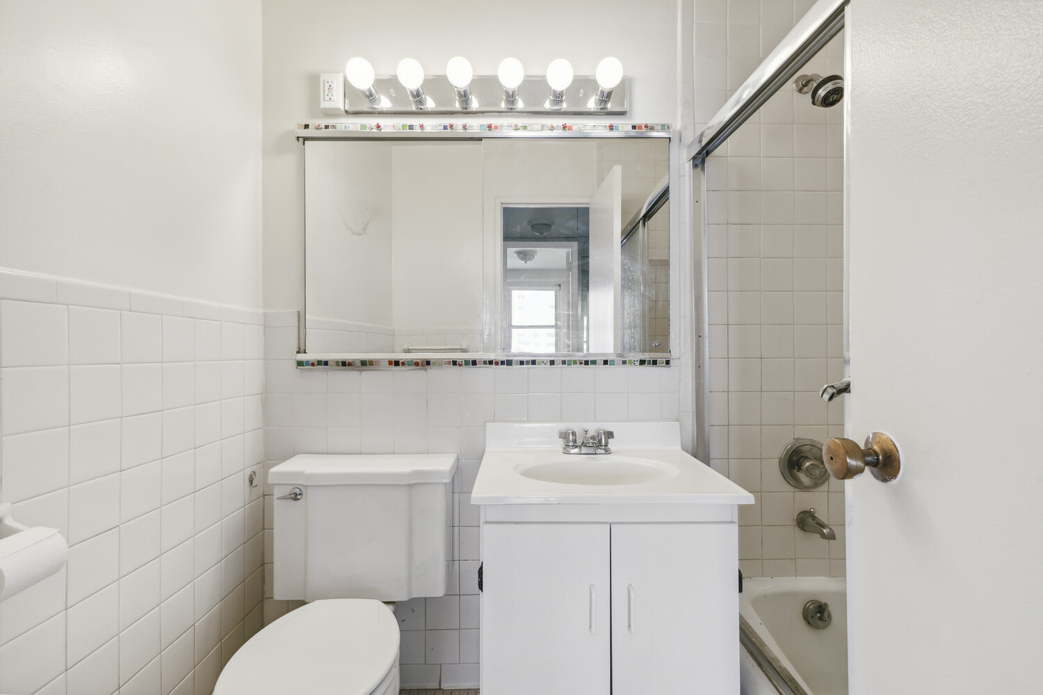 155 West 68th Street, Unit 1807 Manhattan, NY 10023 - Photo 6 of 7 a bathroom with a sink and mirror with toilet