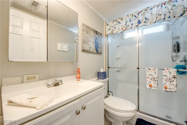 a view of porch with a table and chairs and potted plants
