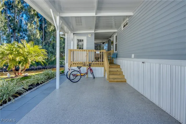 a view of a porch with furniture and garden
