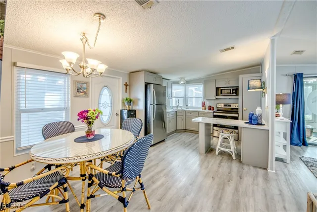 a kitchen with a stove a sink and a refrigerator