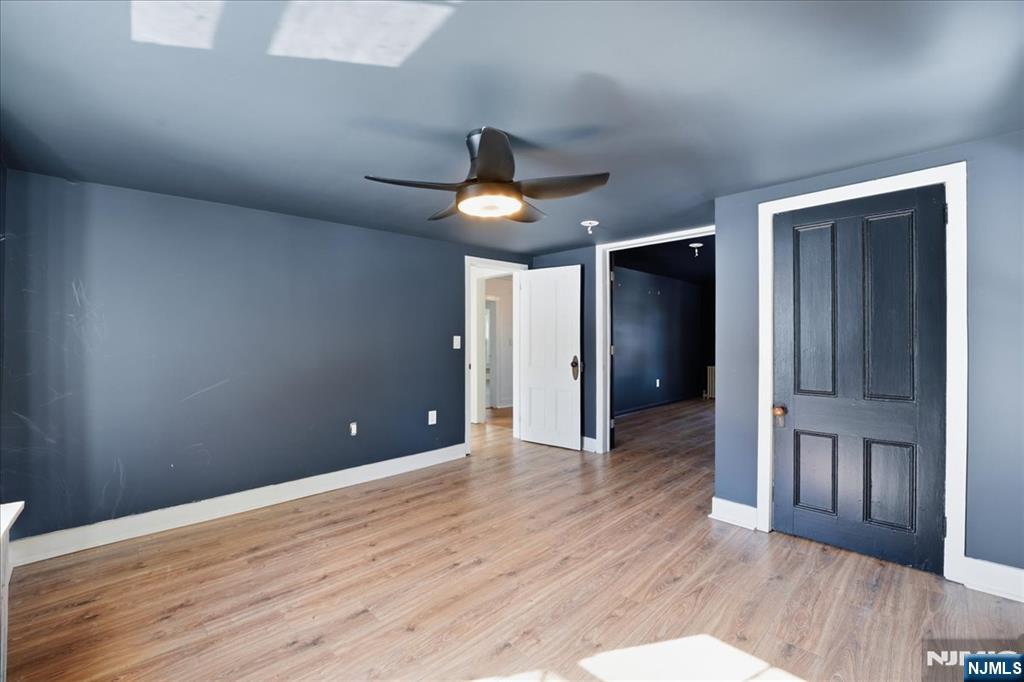 343-339 Quaker Church Road Randolph, NJ 07869 - Photo 14 of 38 a view of an empty room with wooden floor and a ceiling fan