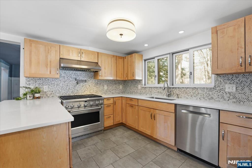 343-339 Quaker Church Road Randolph, NJ 07869 - Photo 26 of 38 a kitchen with a sink stove and cabinets