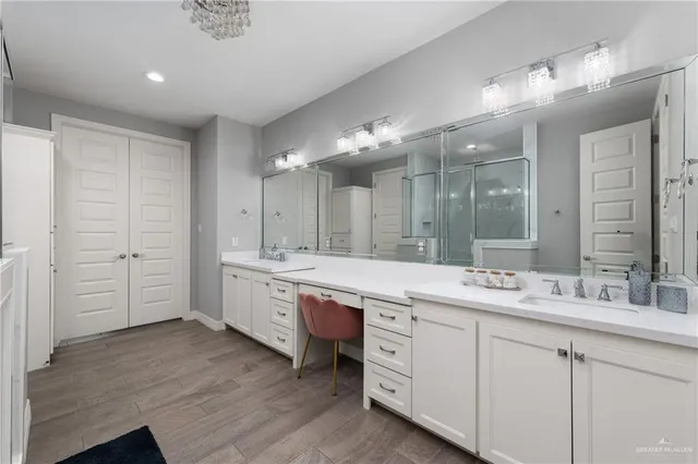 a spacious bathroom with a granite countertop sink mirror and a
