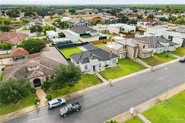 an aerial view of a house with a swimming pool