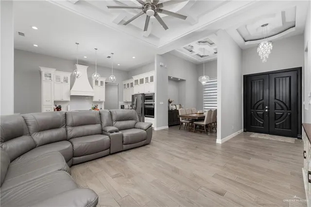 a living room with furniture and a chandelier
