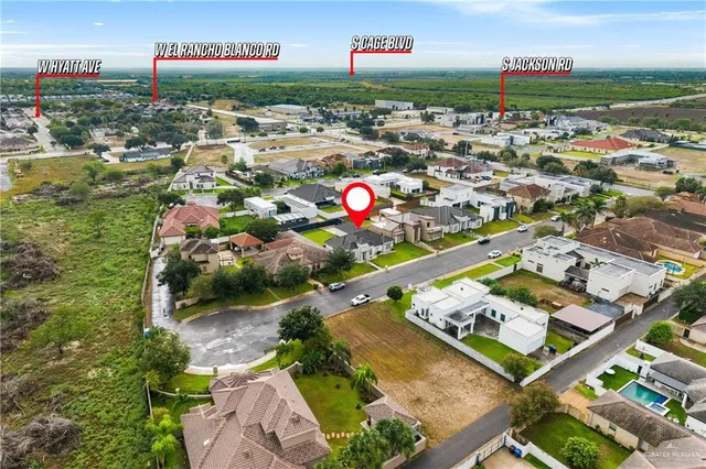 an aerial view of residential houses with outdoor space