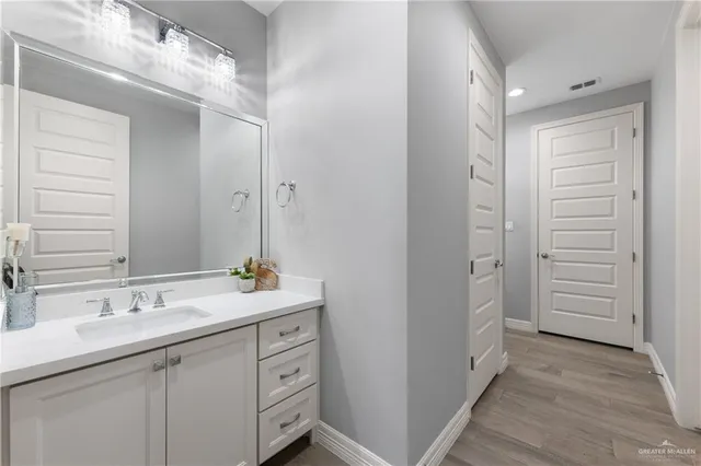 a bathroom with a shower sink and mirror