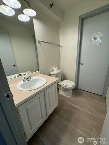 a bathroom with a sink a toilet and a mirror