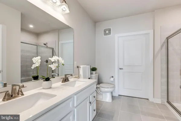 a bathroom with a double vanity sink and a mirror