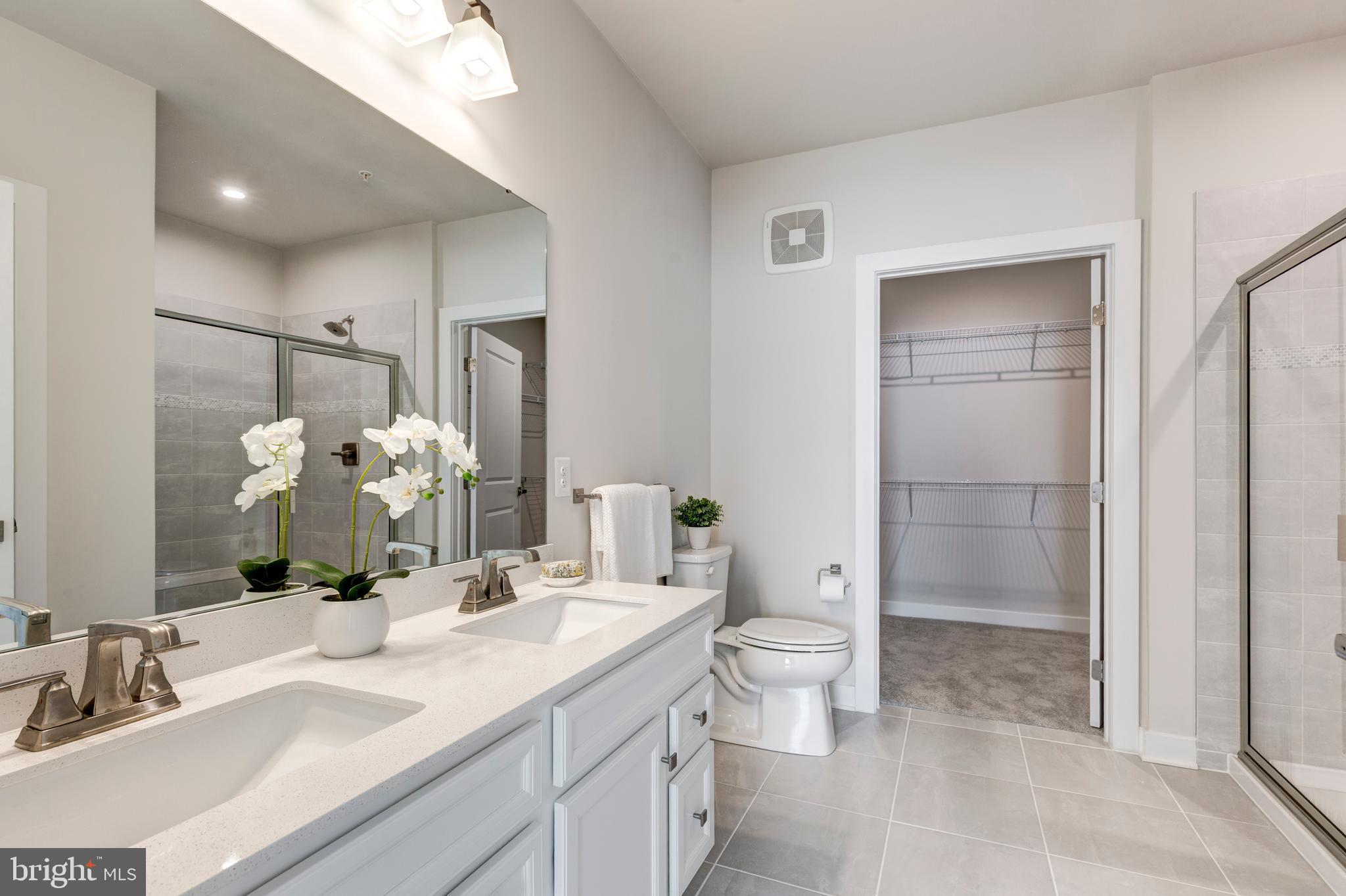 40 Liberty Road, Unit T Sykesville, MD 21784 - Photo 27 of 31 a bathroom with a granite countertop sink a toilet and shower