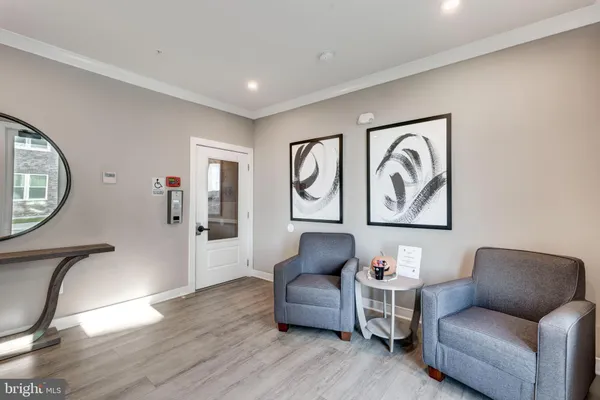 a living room with furniture mirror and a wooden floor