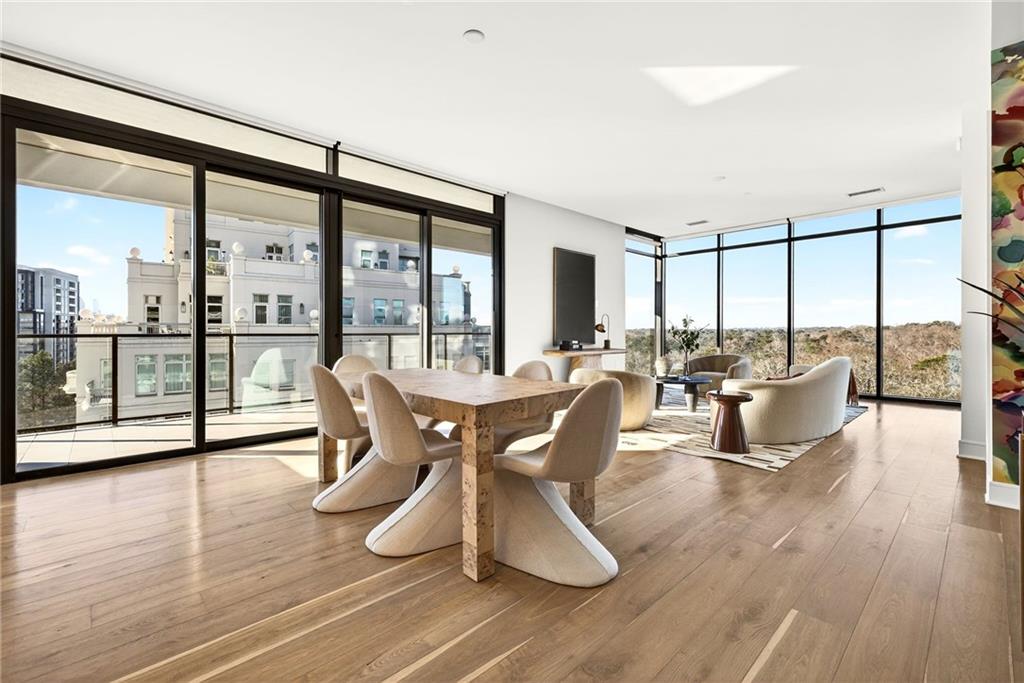 a dining room with furniture window and wooden floor