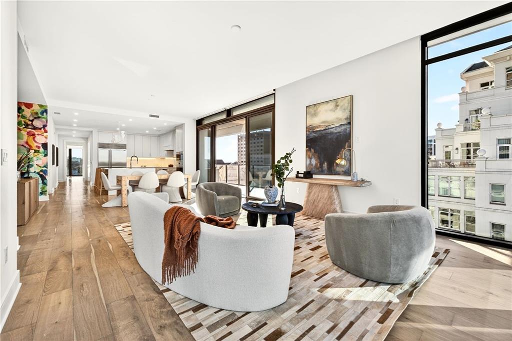 2520 Peachtree Road Northwest, Unit 1003 Atlanta, GA 30305 - Photo 12 of 63 a living room with furniture wooden floor and a large window