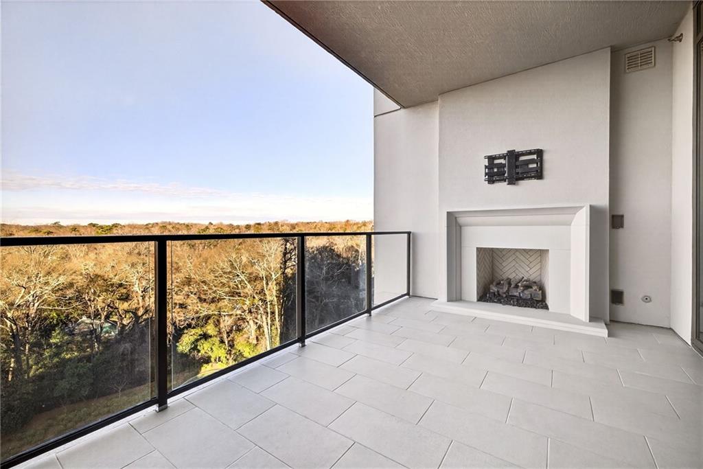 2520 Peachtree Road Northwest, Unit 1003 Atlanta, GA 30305 - Photo 18 of 63 a view of an empty room with a fireplace and a window
