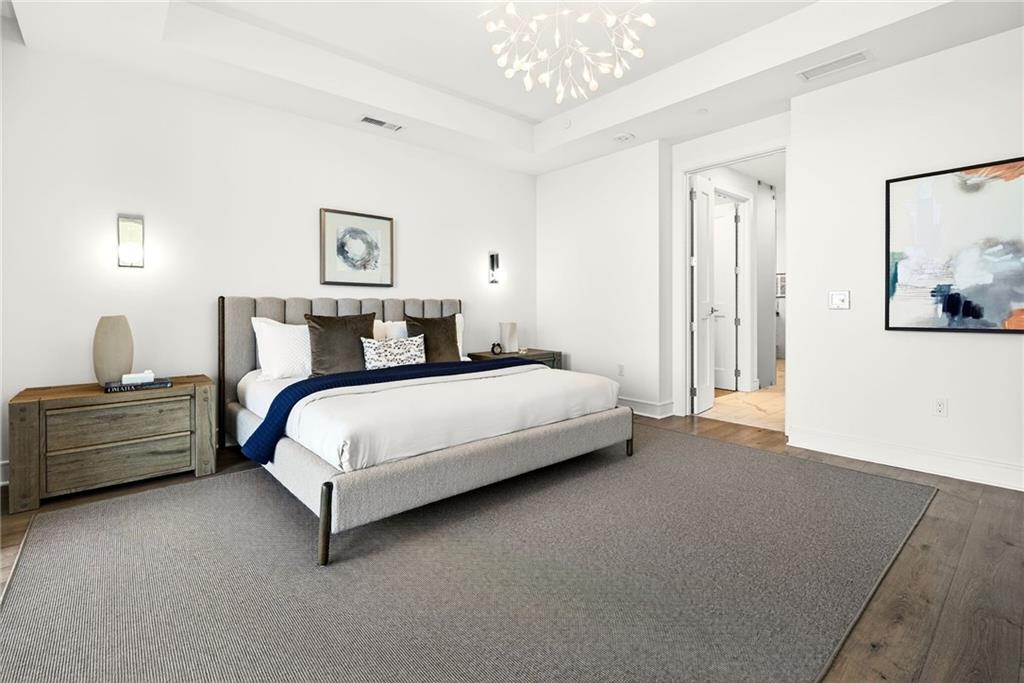 2520 Peachtree Road Northwest, Unit 1003 Atlanta, GA 30305 - Photo 19 of 63 a bedroom with a bed and a chandelier