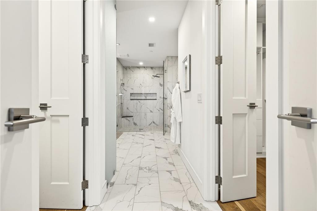 2520 Peachtree Road Northwest, Unit 1003 Atlanta, GA 30305 - Photo 27 of 63 a bathroom with a shower and a glass door