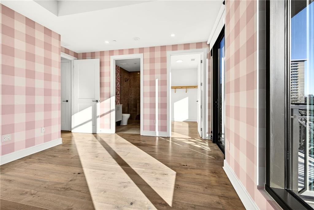 2520 Peachtree Road Northwest, Unit 1003 Atlanta, GA 30305 - Photo 33 of 63 a view of a hallway with wooden floor and windows