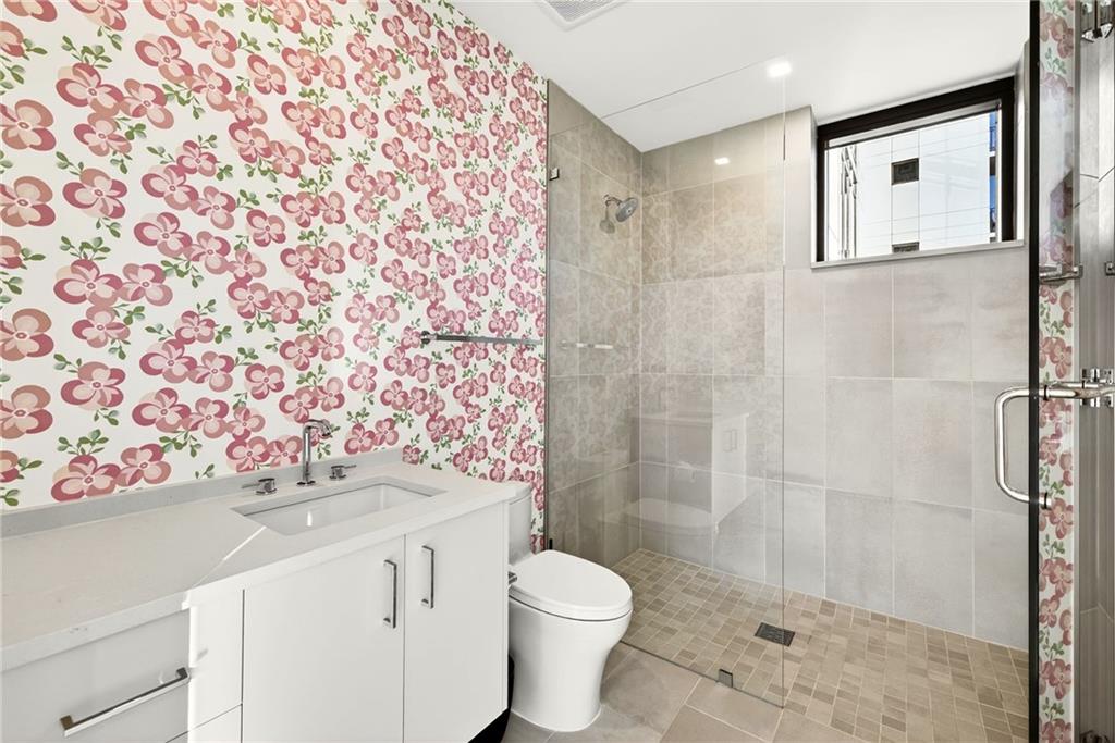 2520 Peachtree Road Northwest, Unit 1003 Atlanta, GA 30305 - Photo 34 of 63 a bathroom with a sink toilet and shower