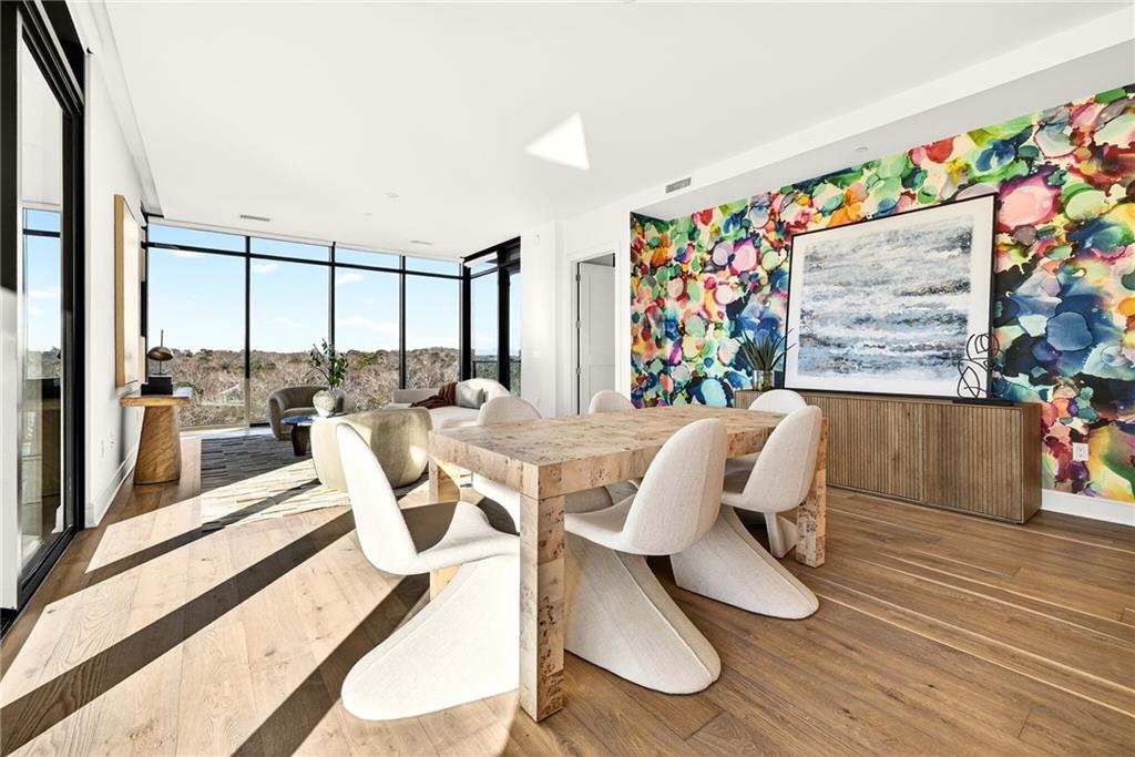 2520 Peachtree Road Northwest, Unit 1003 Atlanta, GA 30305 - Photo 8 of 63 a view of a dining room with furniture one side kitchen view and wooden floor