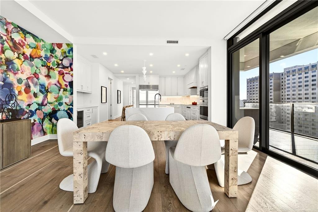 2520 Peachtree Road Northwest, Unit 1003 Atlanta, GA 30305 - Photo 9 of 63 a dining room with furniture a window and wooden floor