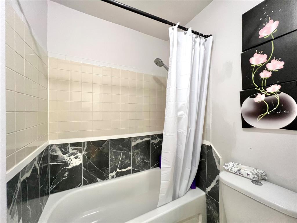 2811 Southwest Archer Road, Unit Z244 Gainesville, FL 32608 - Photo 11 of 18 a bathroom with a tub sink and toilet