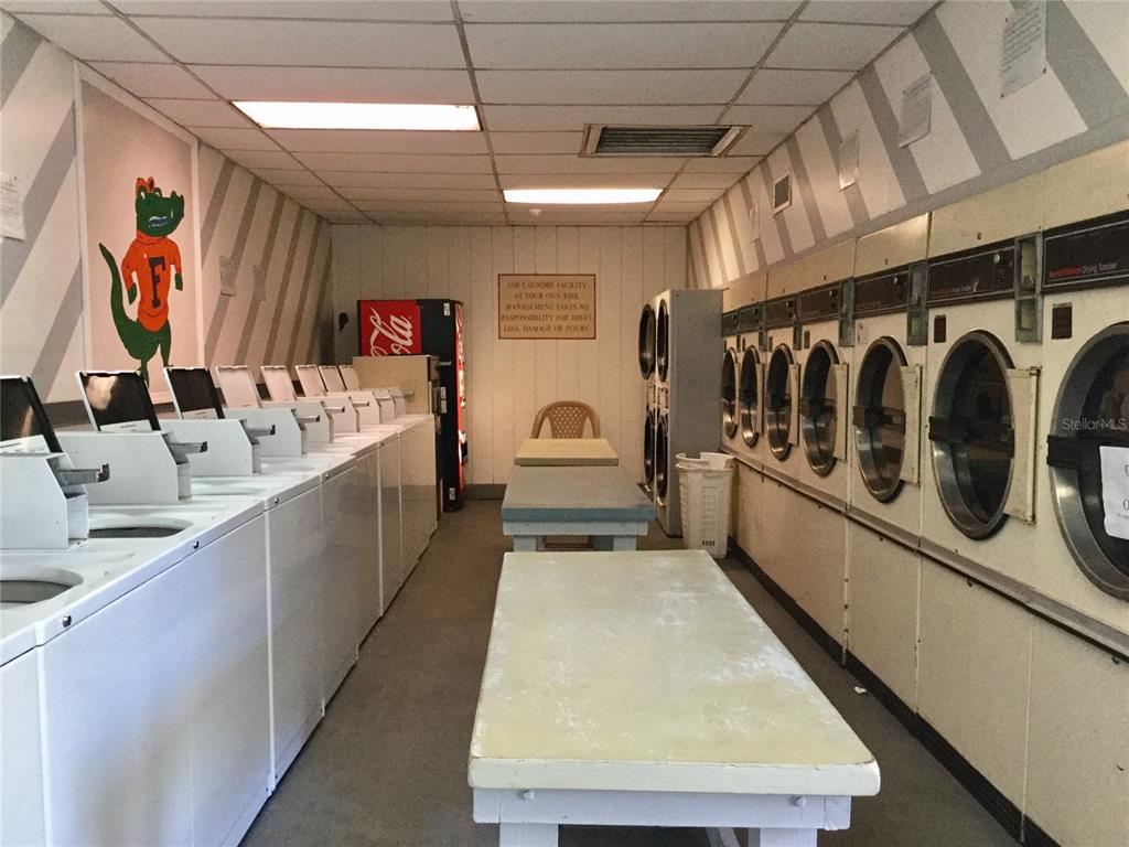 2811 Southwest Archer Road, Unit Z244 Gainesville, FL 32608 - Photo 13 of 18 a kitchen with stainless steel appliances granite countertop a sink and cabinets