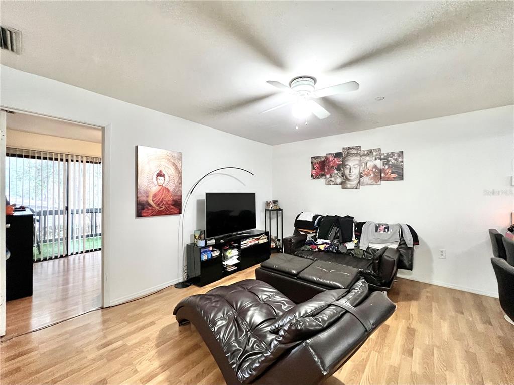 2811 Southwest Archer Road, Unit Z244 Gainesville, FL 32608 - Photo 3 of 18 a living room with furniture and a flat screen tv