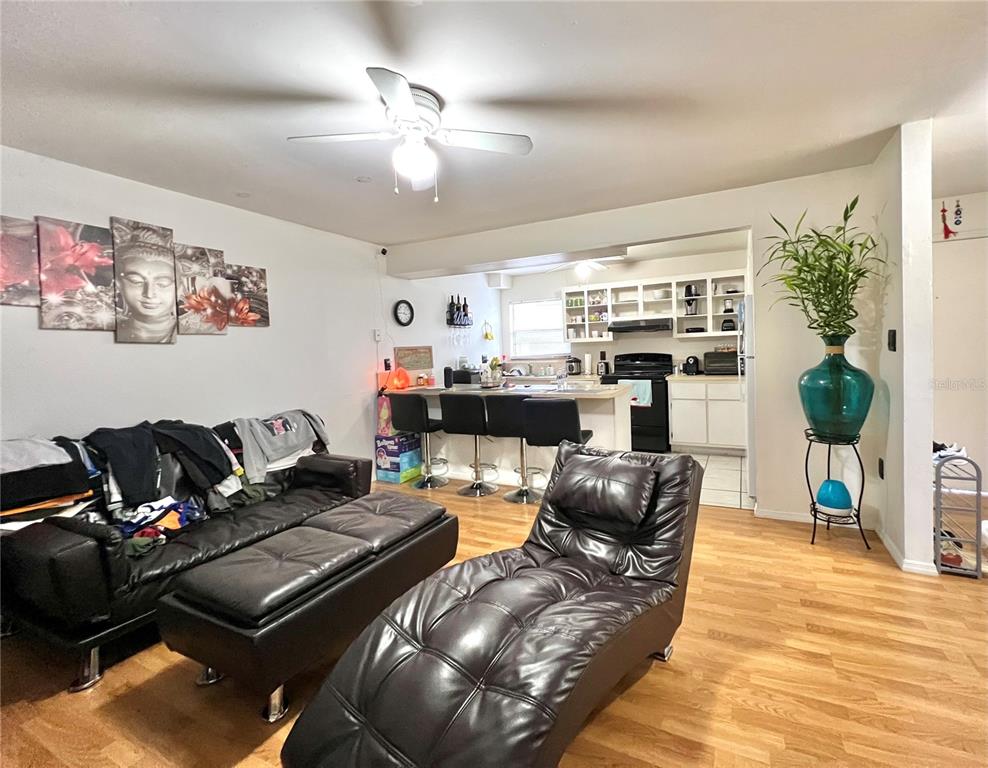 2811 Southwest Archer Road, Unit Z244 Gainesville, FL 32608 - Photo 4 of 18 a living room with furniture and a chandelier