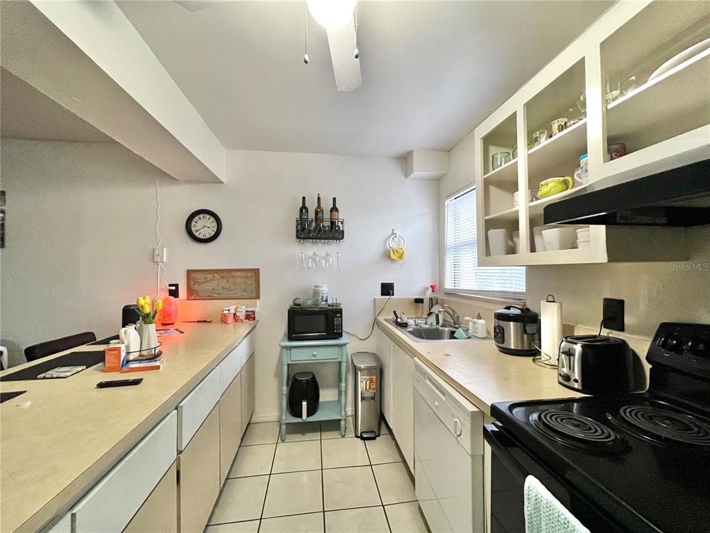 2811 Southwest Archer Road, Unit Z244 Gainesville, FL 32608 - Photo 5 of 18 a kitchen with a sink stove and cabinets