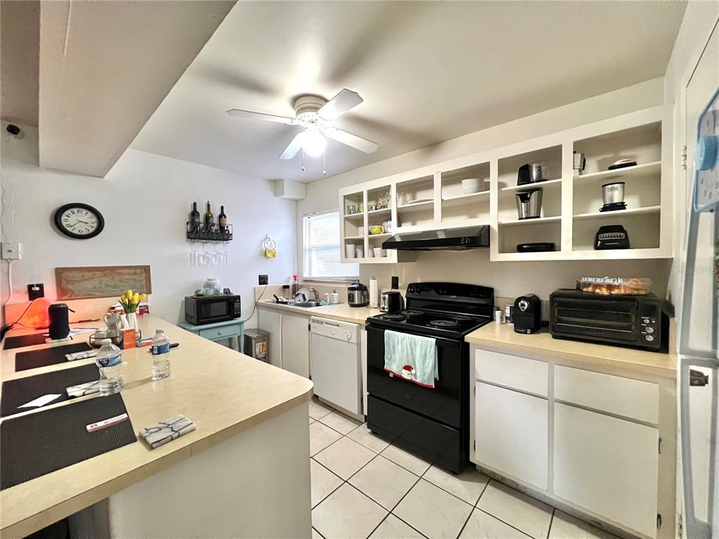 2811 Southwest Archer Road, Unit Z244 Gainesville, FL 32608 - Photo 7 of 18 a kitchen with a stove and a white cabinets
