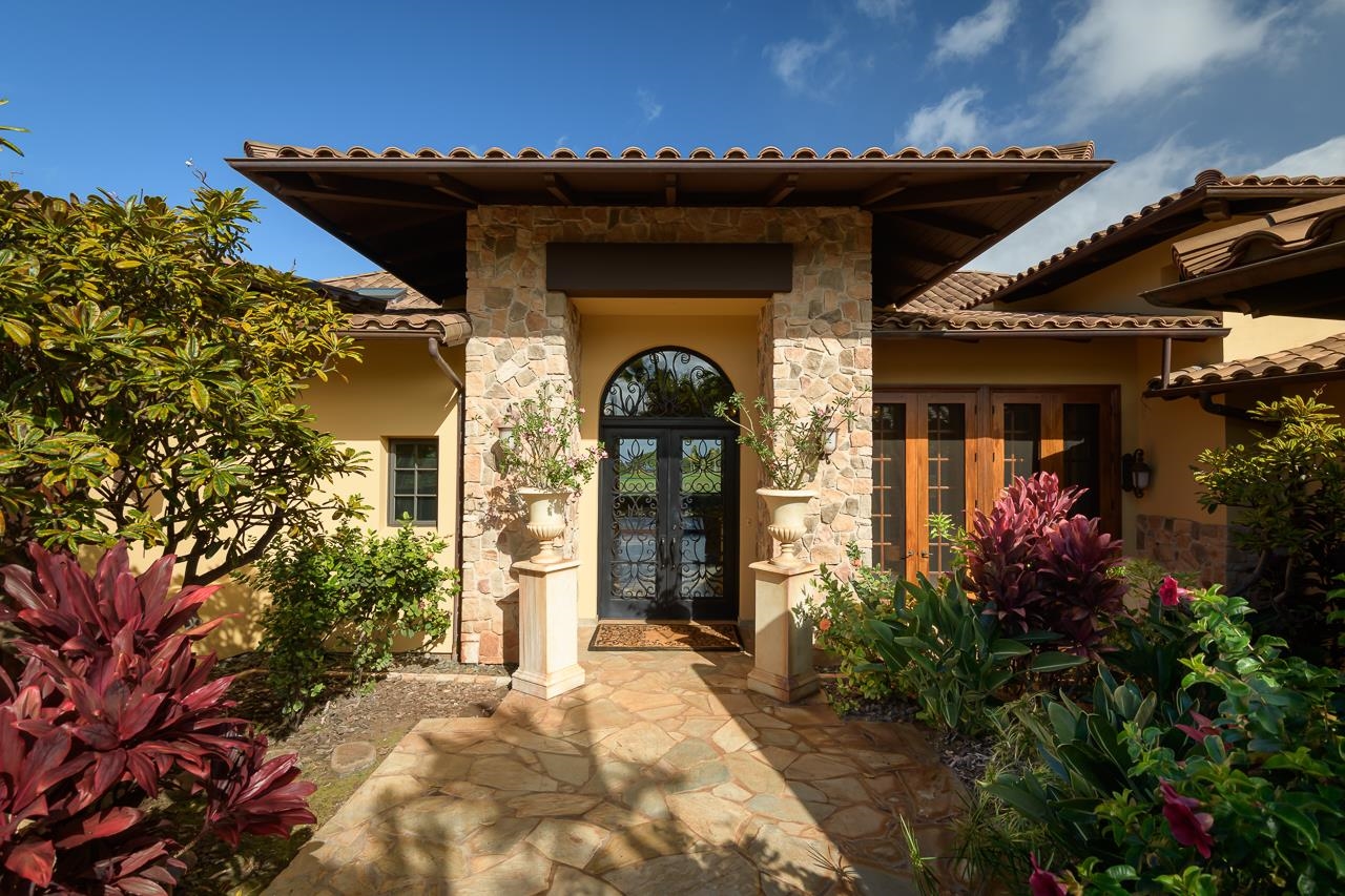 104 Anapuni Loop Lahaina, HI 96761 - Photo 2 of 45 a front view of a house with a lots of flower garden