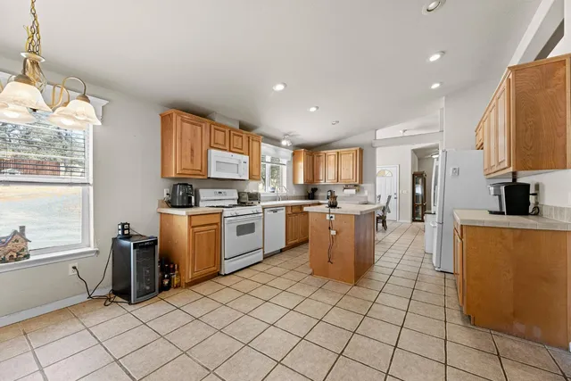 a kitchen with white cabinets and white appliances