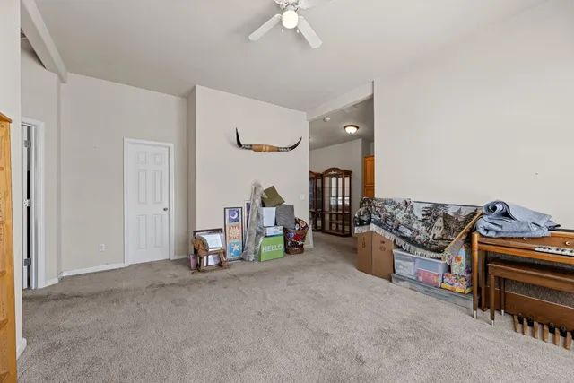a living room with furniture a flat screen tv and a window