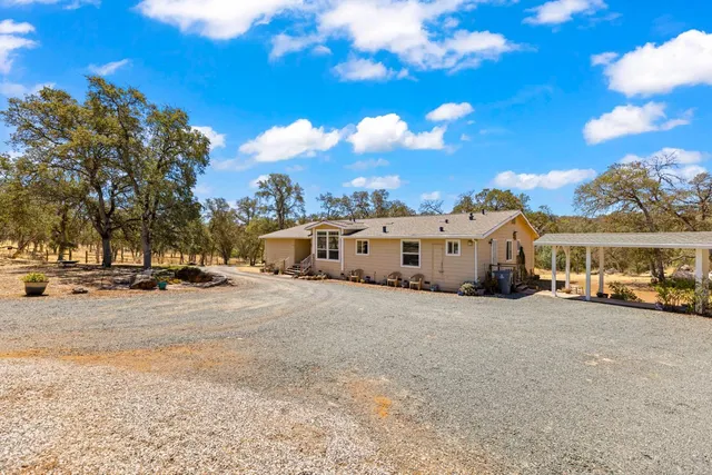 a living room with furniture and a gym machine